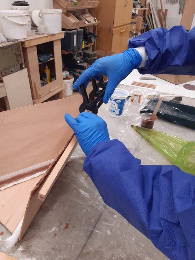 Practising gluing, filleting and taping on a mockup boat on a Fyne Boat Kits epoxy course