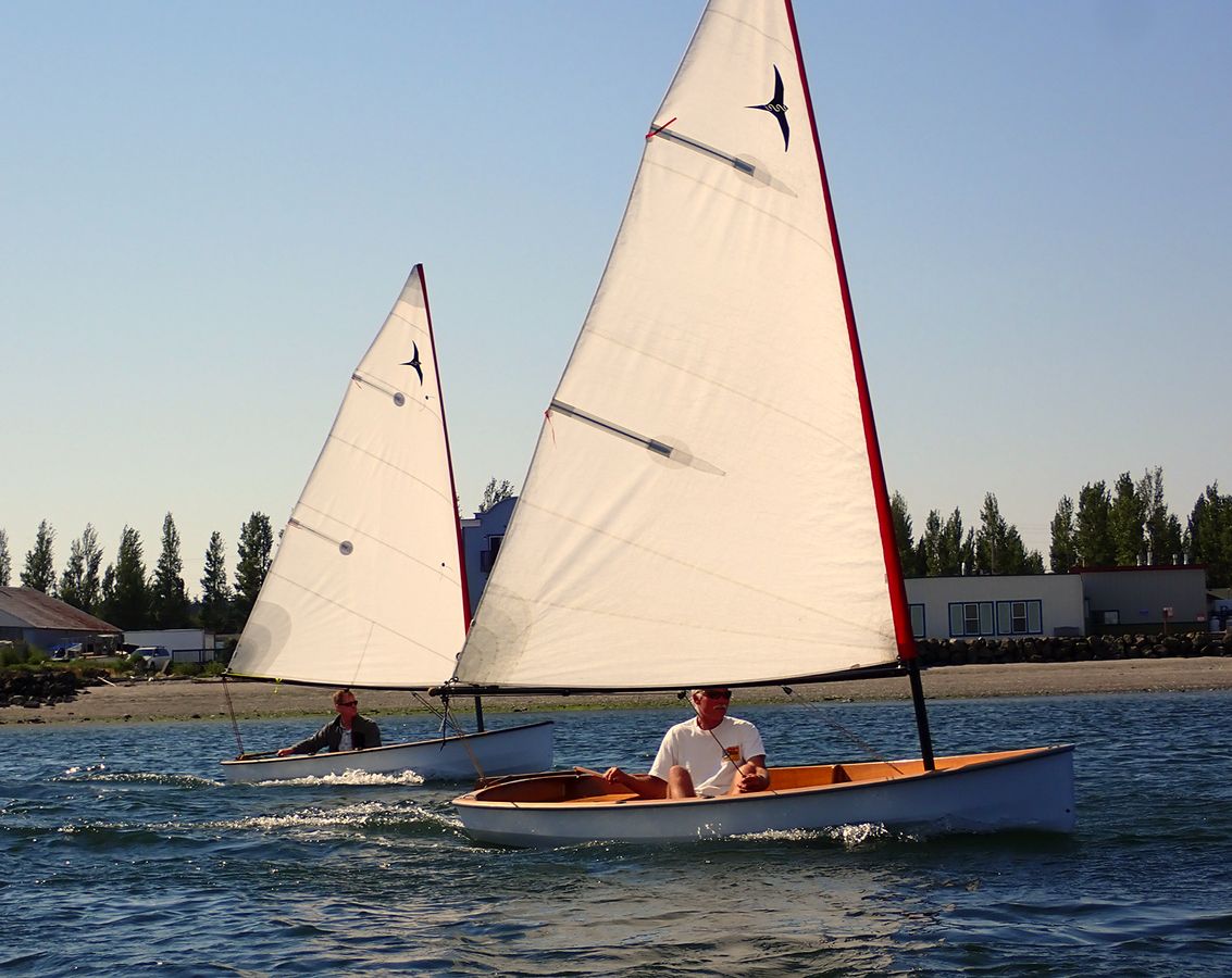 A pair of PT 11 nesting dinghies sailing